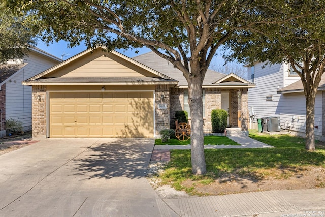 view of front of home featuring a garage, central AC, and a front yard