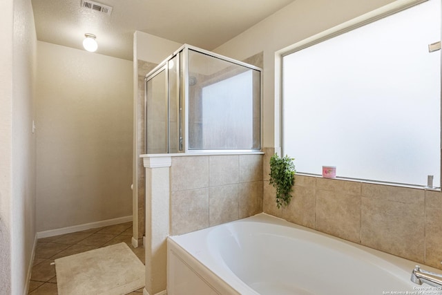 bathroom with tile patterned flooring and plus walk in shower