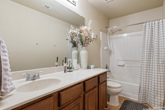 full bathroom featuring toilet, a textured ceiling, vanity, shower / bath combo, and tile patterned flooring