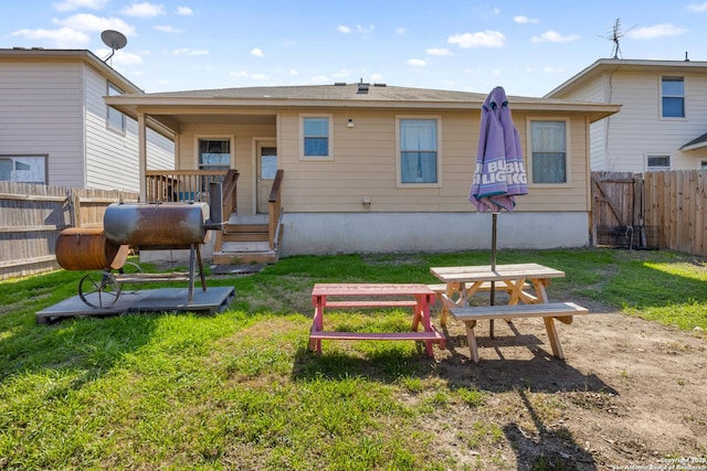 rear view of property featuring a yard