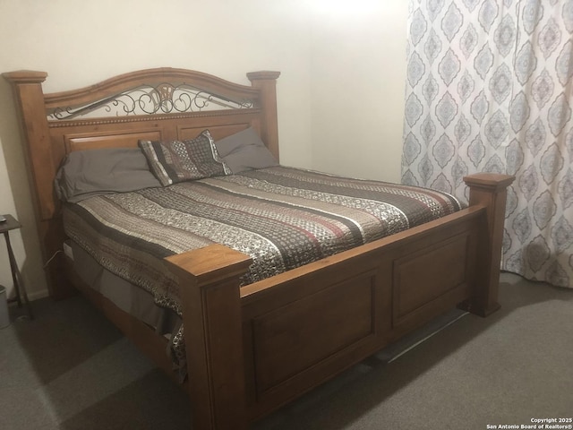 bedroom featuring dark colored carpet