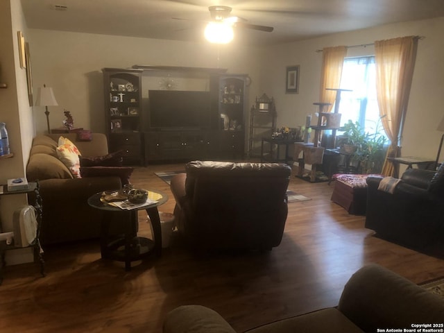 living room featuring ceiling fan and wood finished floors