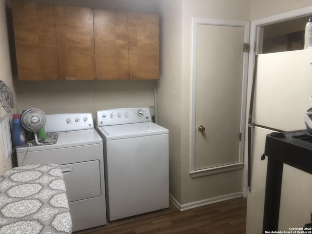 washroom featuring dark wood finished floors and washer and dryer