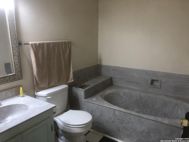 bathroom featuring vanity, toilet, and a bath