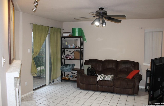 tiled living room featuring ceiling fan and track lighting