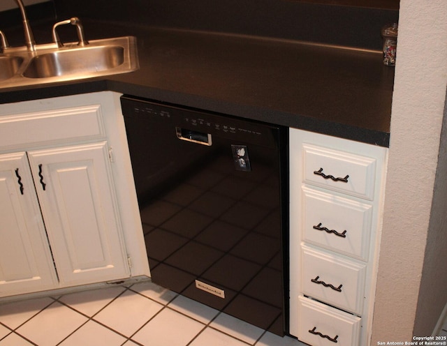 kitchen with white cabinetry, black dishwasher, and sink