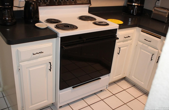 kitchen featuring range with electric stovetop, white cabinetry, and light tile patterned floors