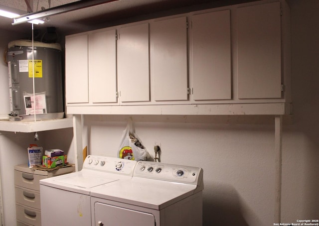 laundry room with water heater, cabinets, and independent washer and dryer