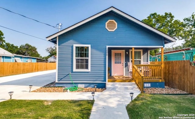 bungalow featuring a front yard and a porch