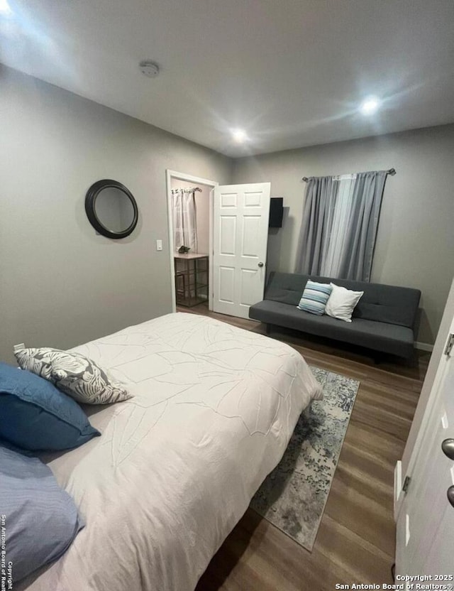 bedroom featuring dark hardwood / wood-style flooring