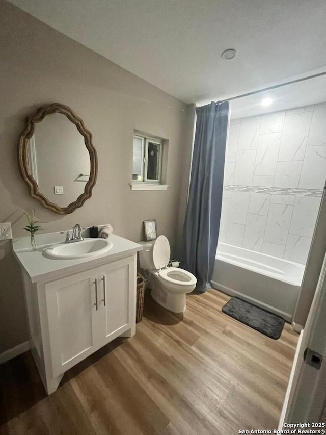 full bathroom with shower / bath combination with curtain, vanity, toilet, and hardwood / wood-style floors