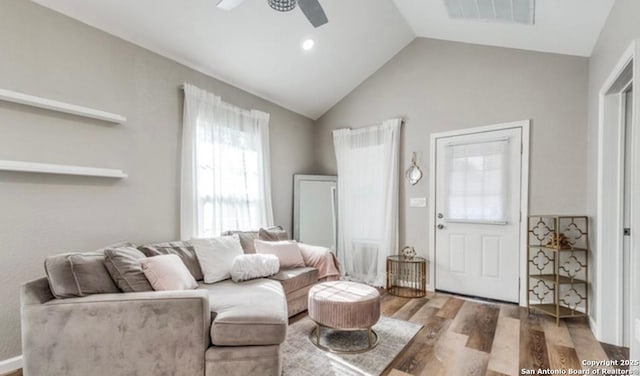 living room featuring vaulted ceiling, hardwood / wood-style floors, and ceiling fan