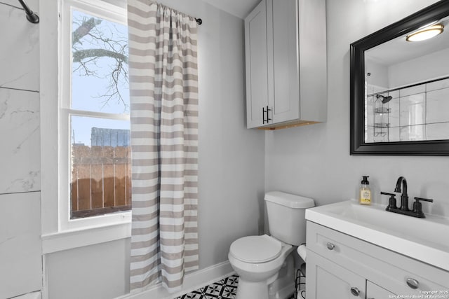 bathroom with vanity, plenty of natural light, and toilet