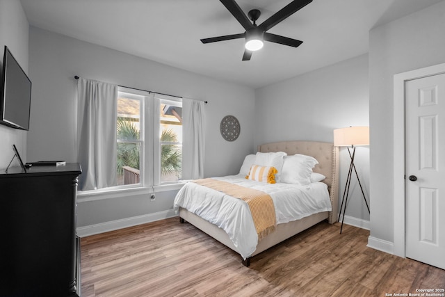 bedroom with hardwood / wood-style flooring and ceiling fan