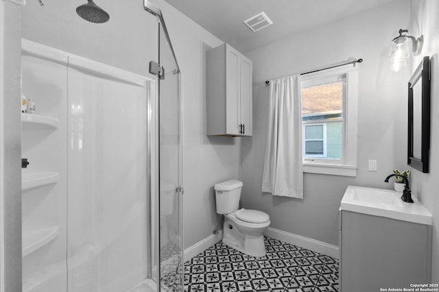 bathroom featuring walk in shower, vanity, and toilet