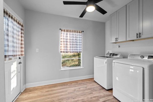 clothes washing area with separate washer and dryer, cabinets, ceiling fan, and light wood-type flooring