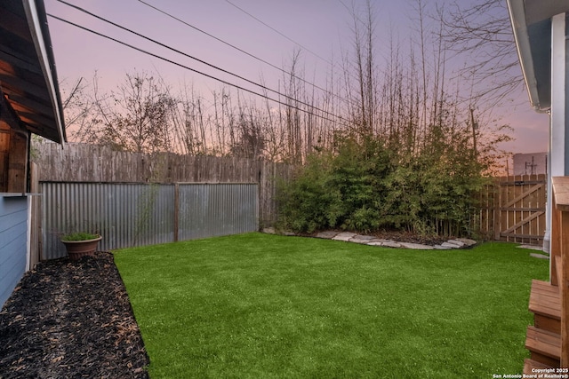 view of yard at dusk