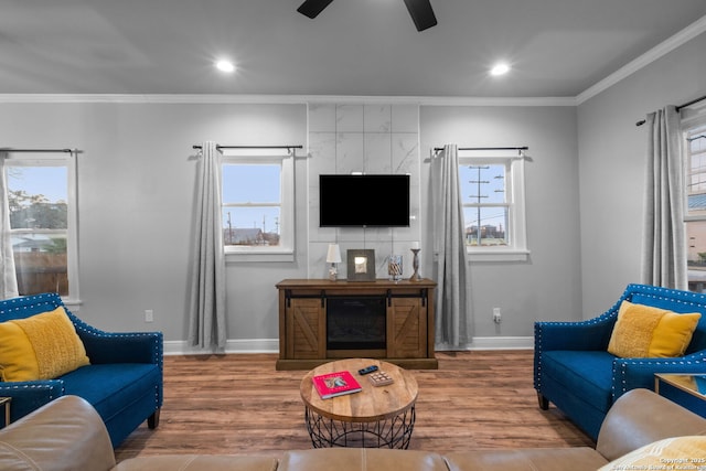 living room featuring crown molding, plenty of natural light, and hardwood / wood-style flooring