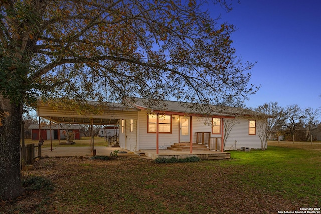 rear view of property with a patio and a lawn