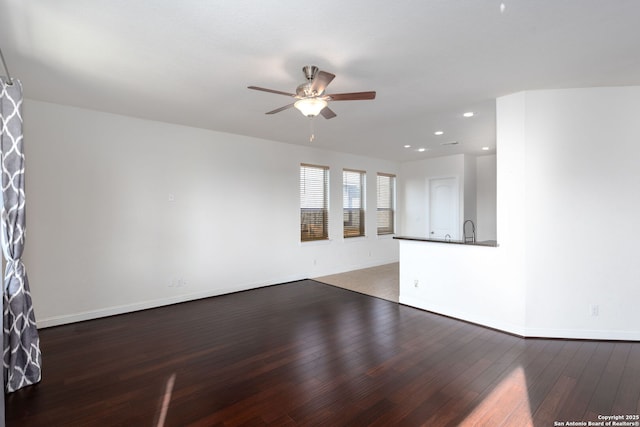 empty room with hardwood / wood-style flooring, sink, and ceiling fan