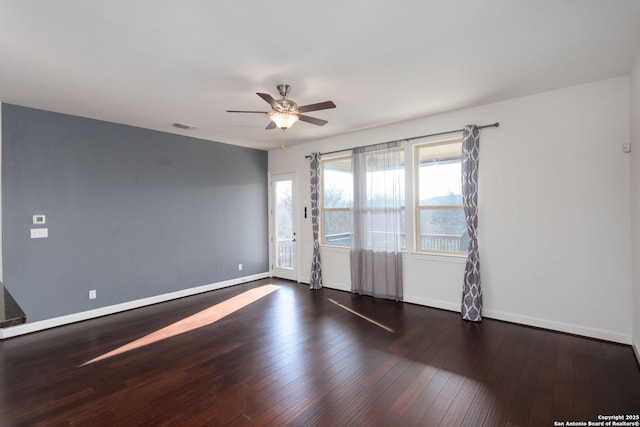 unfurnished room featuring dark hardwood / wood-style flooring and ceiling fan