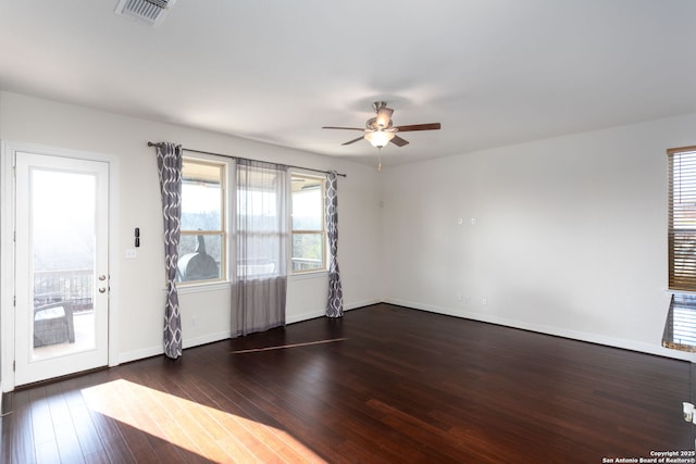 spare room featuring dark wood-type flooring and ceiling fan