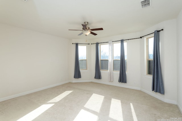 carpeted empty room featuring ceiling fan