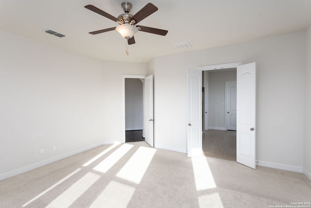 unfurnished bedroom featuring ceiling fan and light carpet