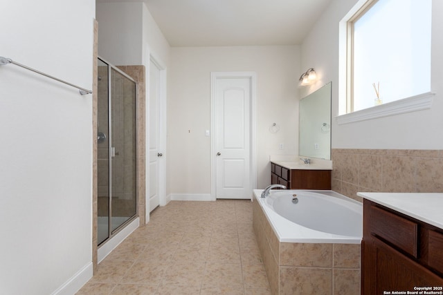 bathroom with vanity, tile patterned flooring, and shower with separate bathtub