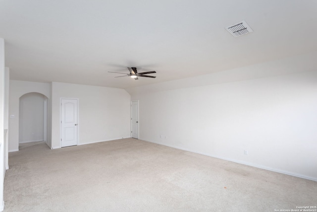 spare room featuring light carpet and ceiling fan