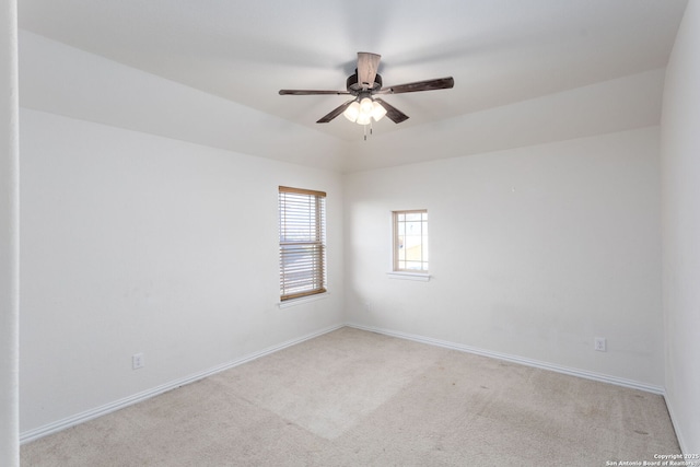 carpeted spare room featuring ceiling fan