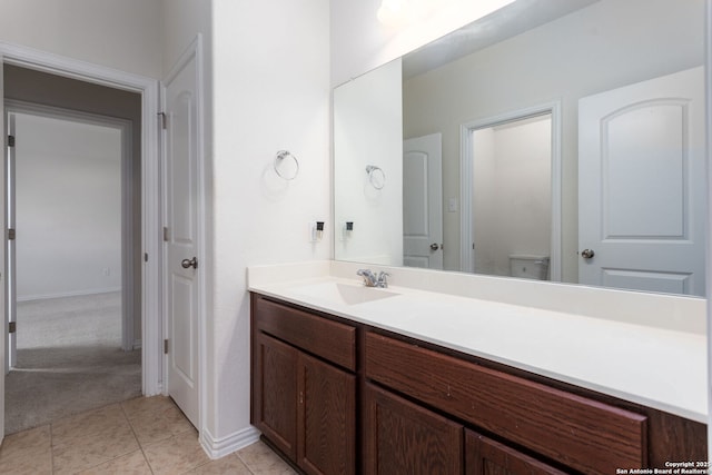 bathroom with vanity, tile patterned floors, and toilet