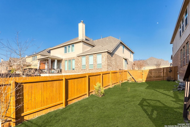 rear view of house with a yard