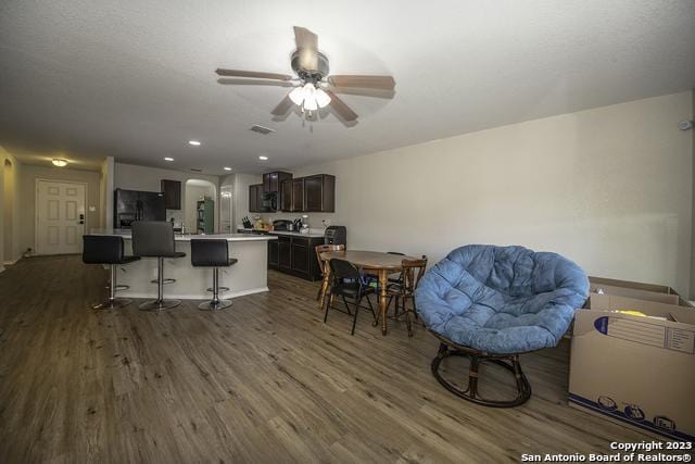 dining room with ceiling fan and dark hardwood / wood-style flooring