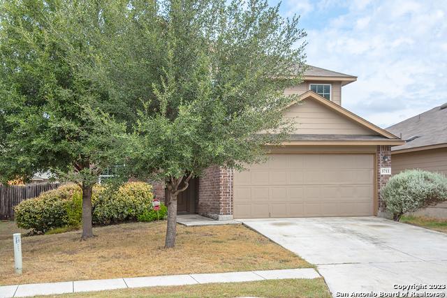 obstructed view of property with a garage