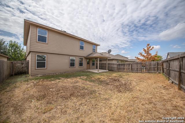 back of property featuring a lawn