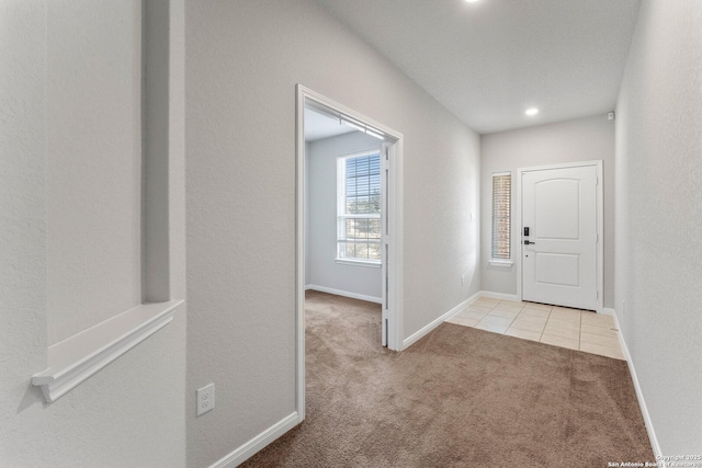 foyer entrance featuring light colored carpet