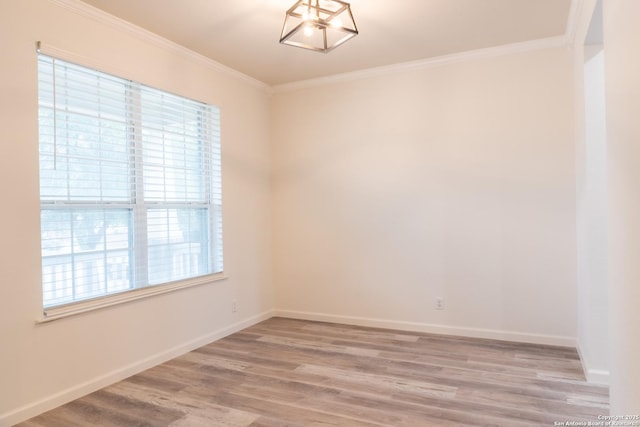 unfurnished room with crown molding, light hardwood / wood-style floors, and a chandelier