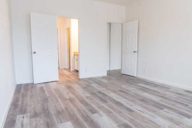 unfurnished bedroom with light wood-type flooring