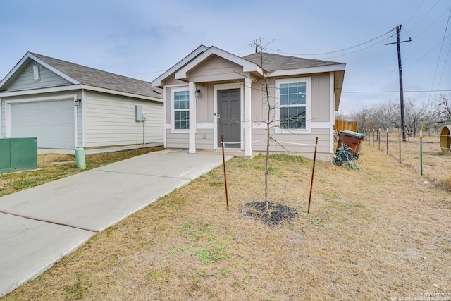 view of front of home with a garage and a front lawn