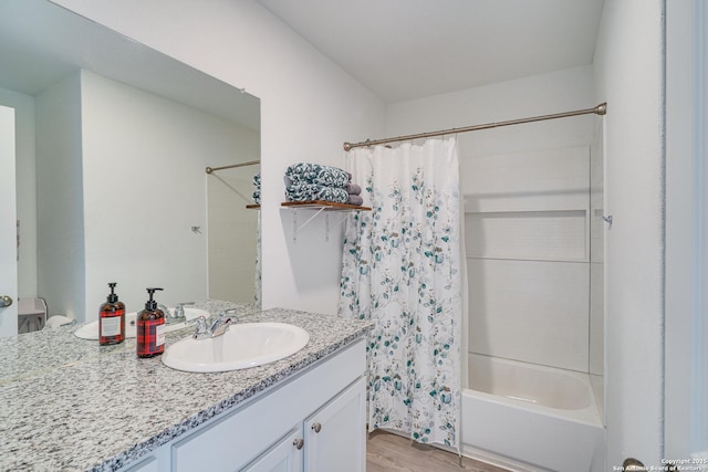 bathroom with shower / bath combination with curtain, vanity, and hardwood / wood-style flooring