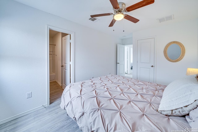 bedroom featuring connected bathroom, ceiling fan, and light wood-type flooring