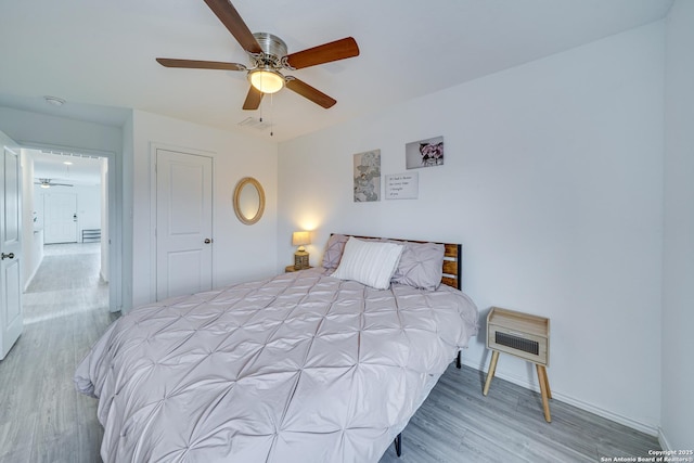 bedroom with ceiling fan and light wood-type flooring