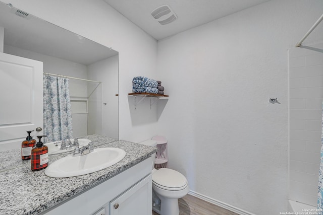 bathroom featuring vanity, curtained shower, toilet, and hardwood / wood-style flooring