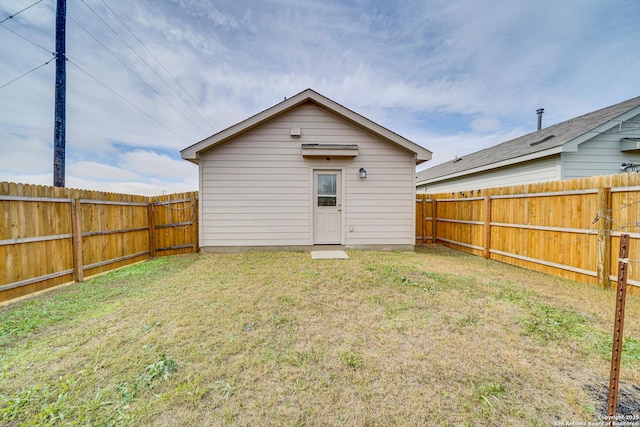 back of property featuring a lawn