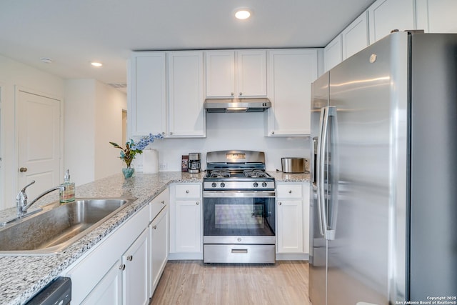 kitchen featuring stainless steel appliances, white cabinetry, and sink