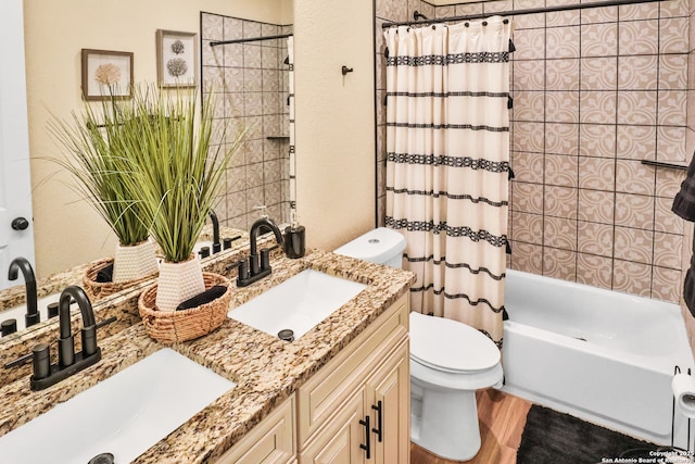 full bathroom featuring vanity, hardwood / wood-style flooring, toilet, and shower / bath combo with shower curtain