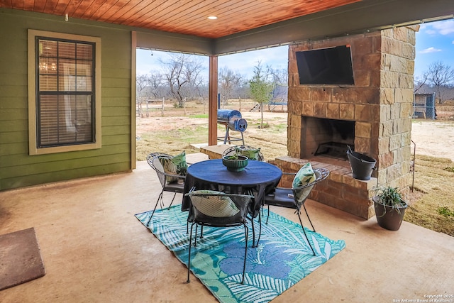 view of patio / terrace with an outdoor stone fireplace