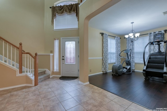 foyer with light hardwood / wood-style flooring and a notable chandelier