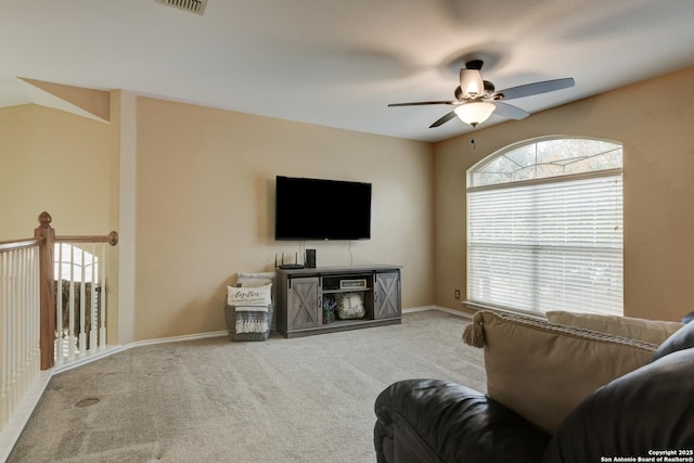 carpeted living room with ceiling fan